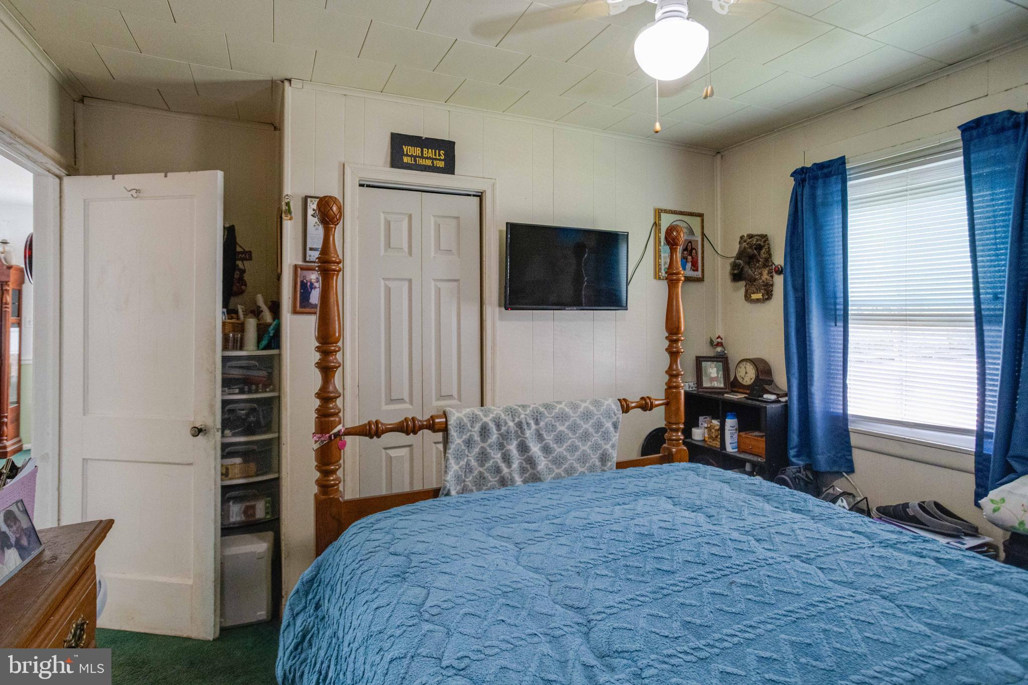 900 Renfrew Street Baltimore, MD 21221 - Photo 22 of 40 a bedroom with furniture and a flat tv screen