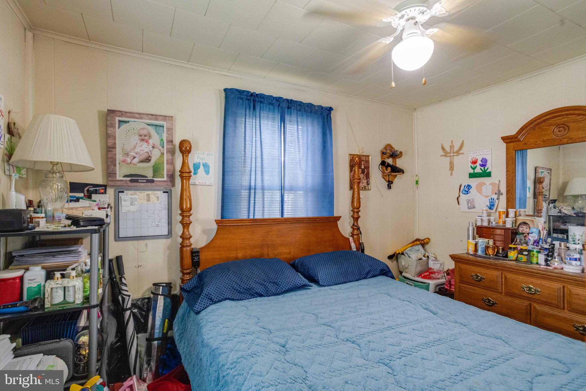 900 Renfrew Street Baltimore, MD 21221 - Photo 23 of 40 a bedroom with furniture and a chandelier