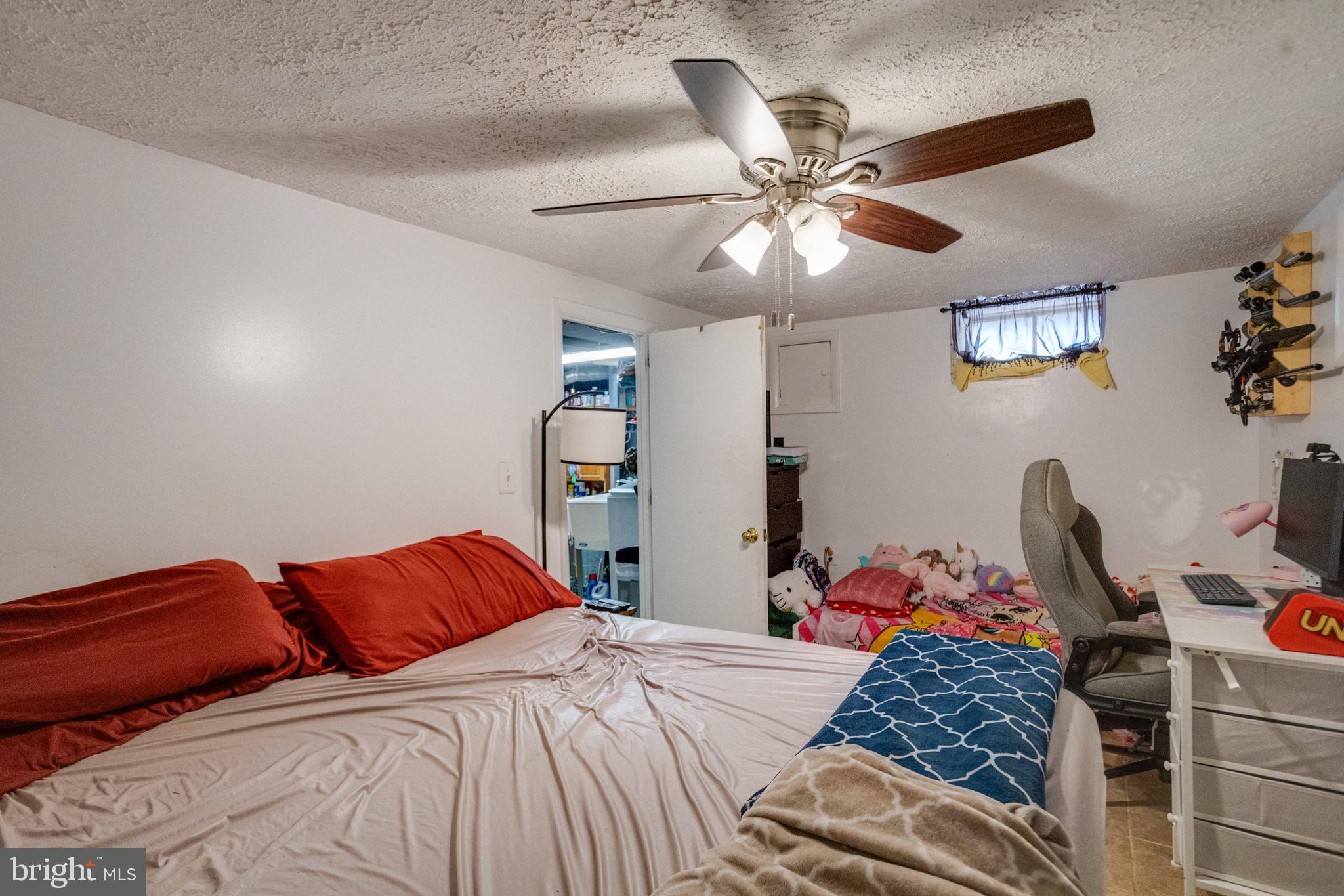 900 Renfrew Street Baltimore, MD 21221 - Photo 32 of 40 a bedroom with a bed and a chandelier