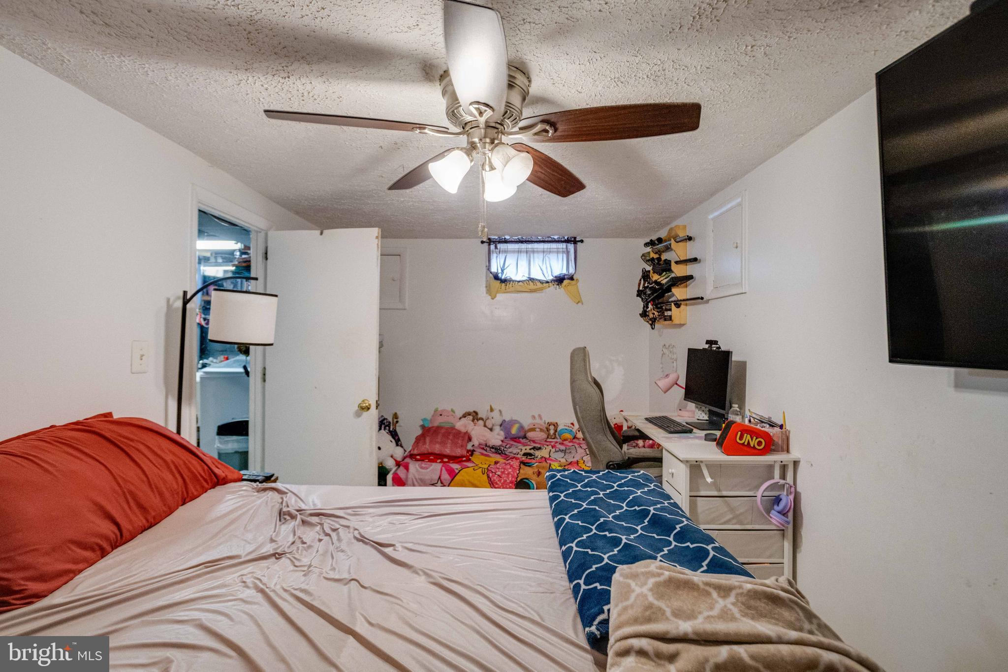 900 Renfrew Street Baltimore, MD 21221 - Photo 33 of 40 a bedroom with a bed and a chandelier