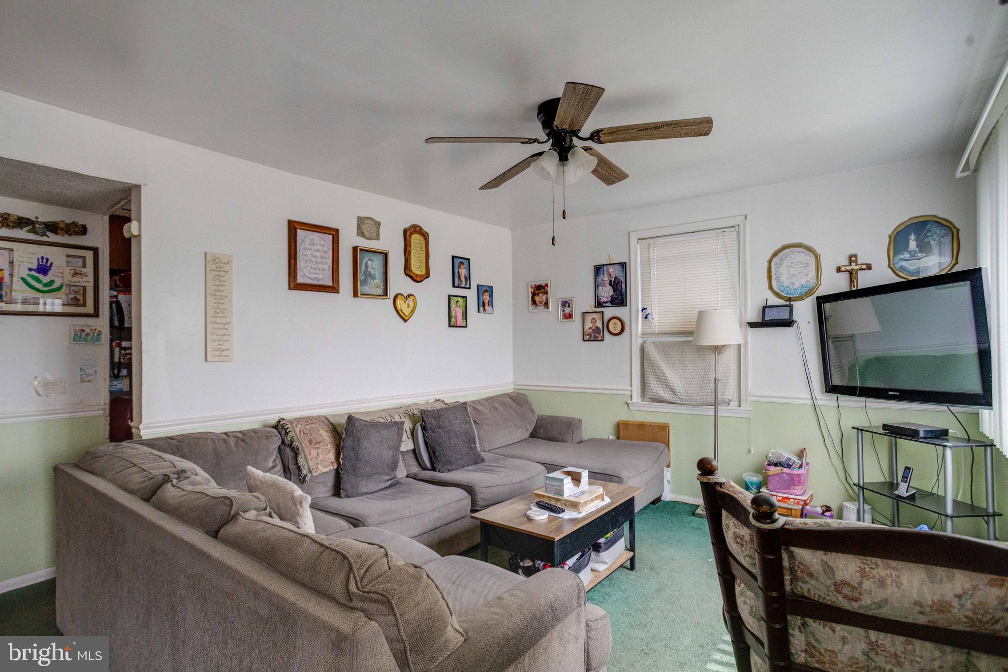 900 Renfrew Street Baltimore, MD 21221 - Photo 5 of 40 a living room with furniture and a flat screen tv