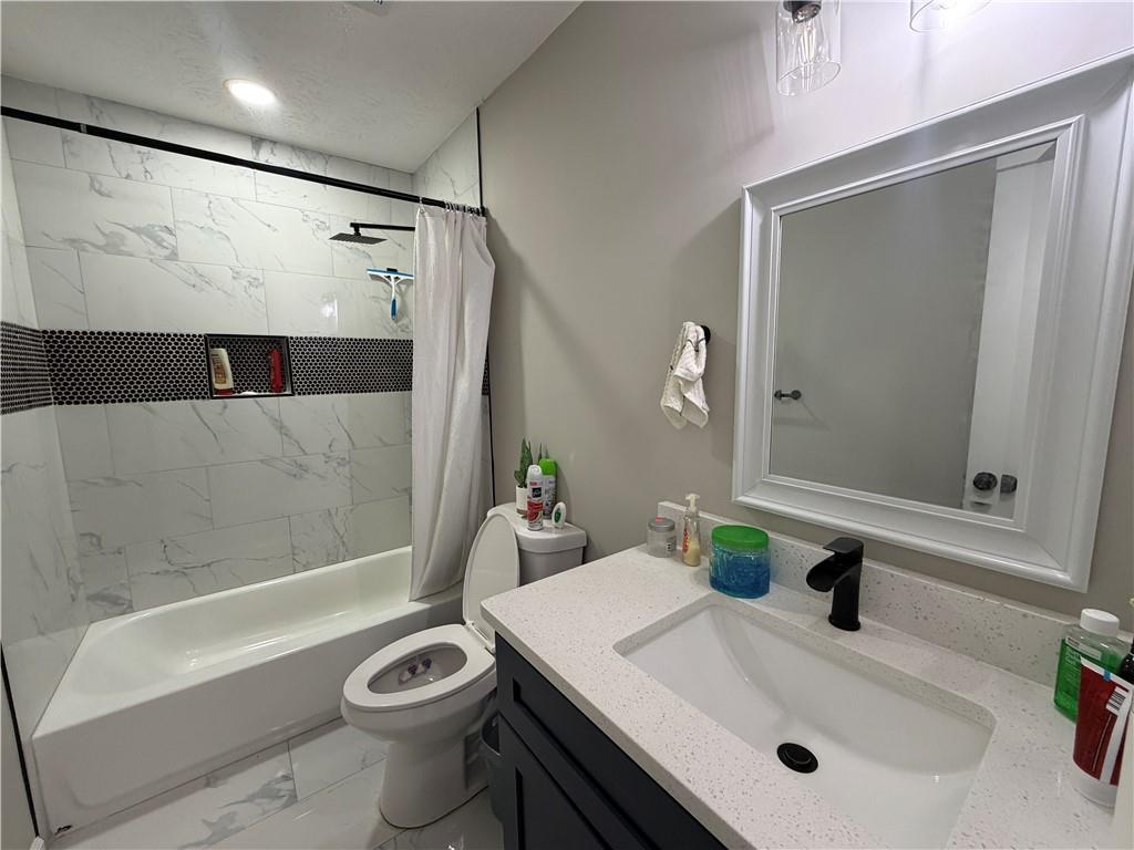 934 Bay Ridge Drive Lawrenceville, GA 30045 - Photo 38 of 78 a bathroom with a sink a toilet and shower