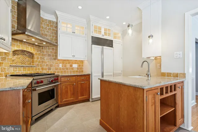 a kitchen with stainless steel appliances granite countertop a stove sink and cabinets