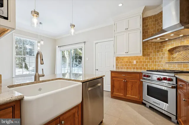 a kitchen with granite countertop a sink stainless steel appliances and cabinets