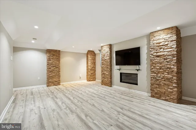 a view of an empty room with a fireplace and a window