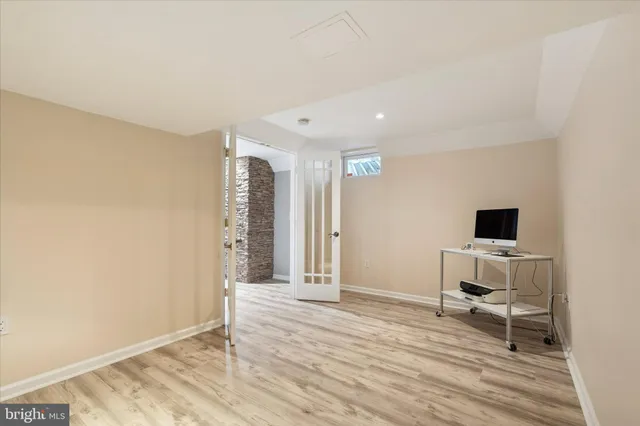 a workspace with wooden floor and bedroom