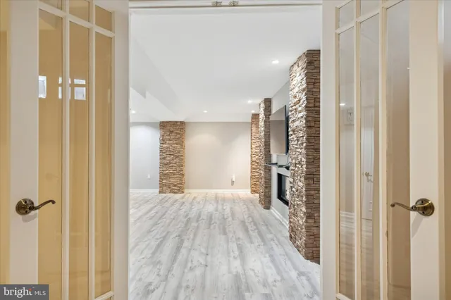 a view of a hallway with wooden floor and staircase