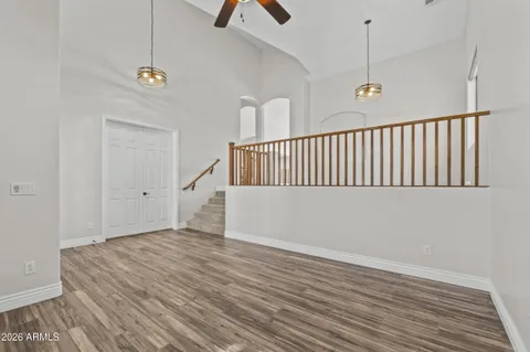 a view of a livingroom with wooden floor and a ceiling fan