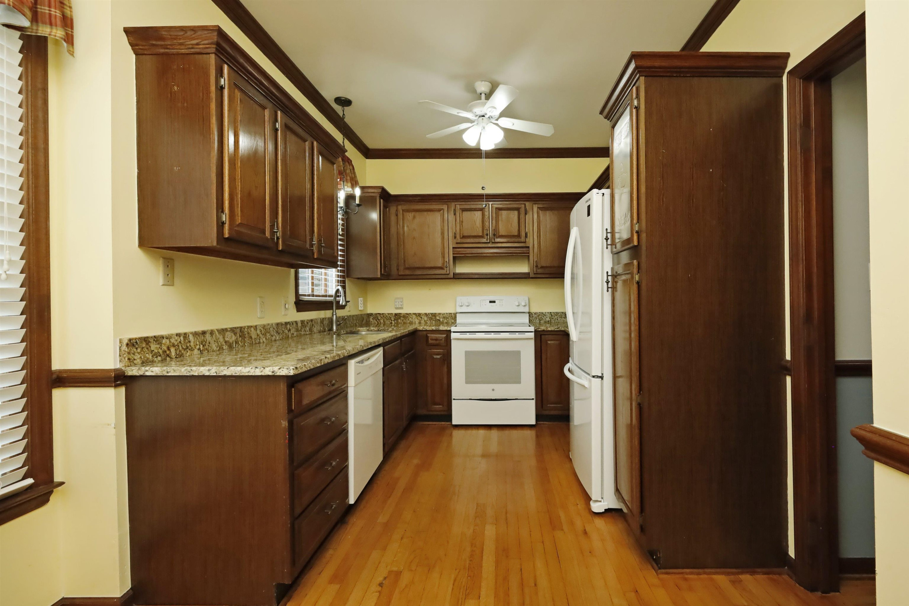 924 Albany Court Raleigh, NC 27615 - Photo 14 of 33 a kitchen with stainless steel appliances granite countertop a refrigerator a sink dishwasher a stove with wooden cabinets and floor