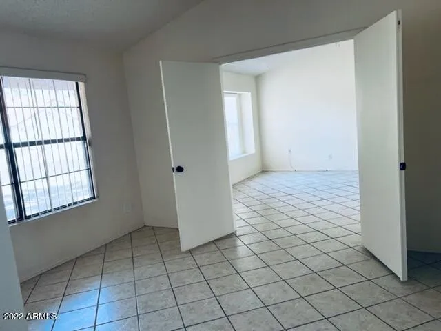 a view of a livingroom with a chandelier fan and closet area