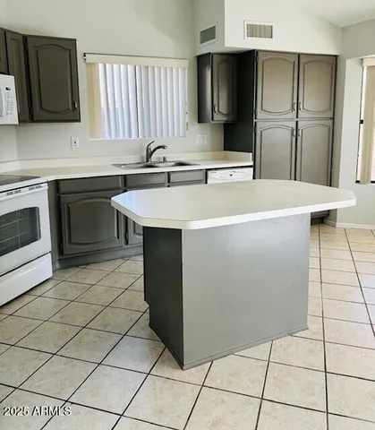 a kitchen with stainless steel appliances a sink and a refrigerator
