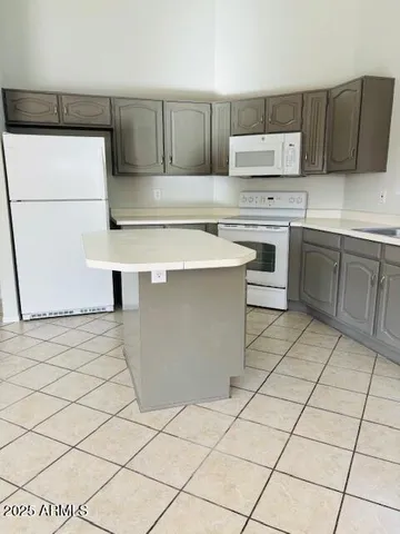 a kitchen with stainless steel appliances a stove a sink and a refrigerator