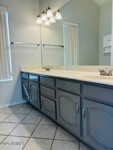 a bathroom with a double vanity sink a mirror and a bathtub