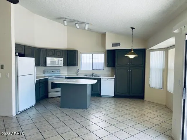 a kitchen with stainless steel appliances a refrigerator sink and microwave