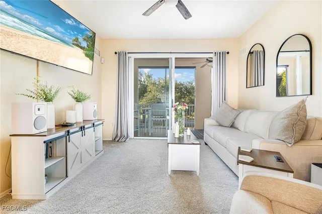 a living room with furniture and potted plant