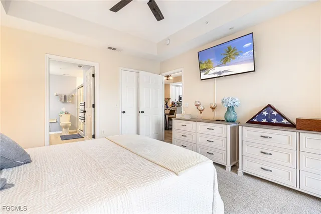a spacious bathroom with a toilet sink double vanity and mirror