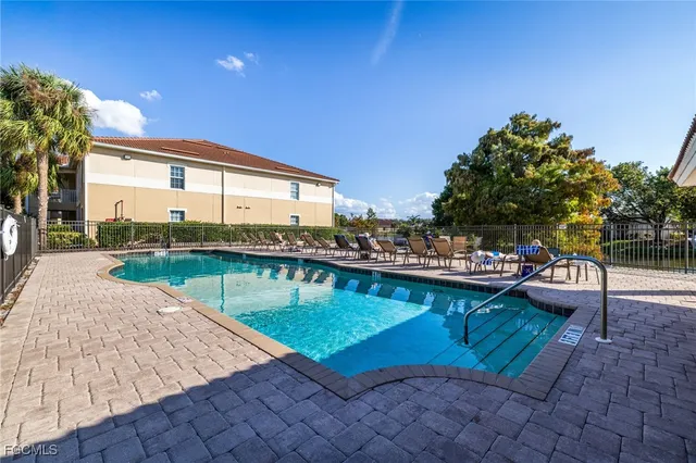 a view of swimming pool with outdoor seating and a potted plant