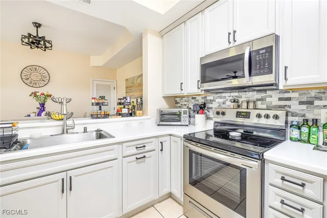 a kitchen with granite countertop a sink stove and cabinets