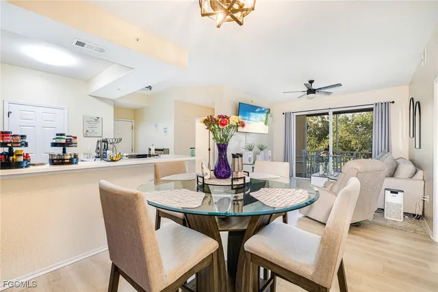 a view of a dining room with furniture and a chandelier