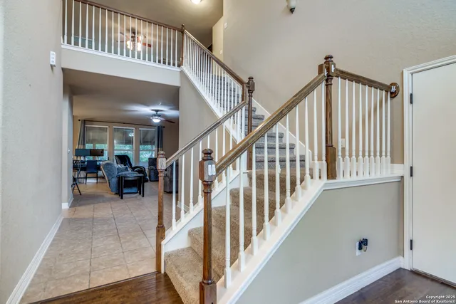a view of staircase and living room with wooden floor and a stairs