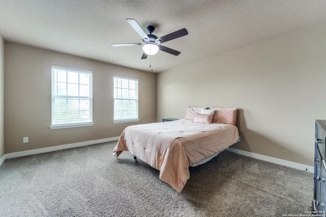 a spacious bedroom with a bed and window