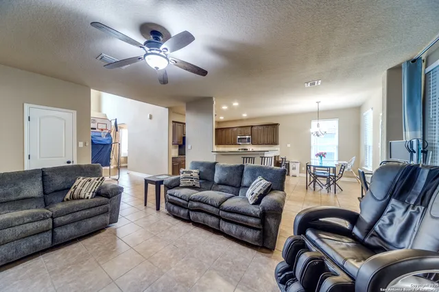 a living room with furniture and a chandelier