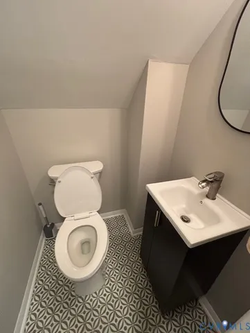 a bathroom with a sink toilet and a mirror