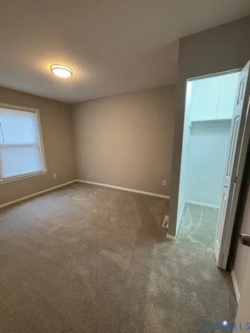 an empty room with a empty space and windows