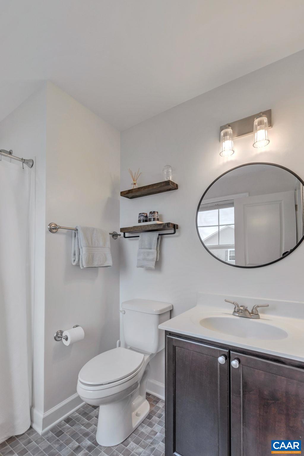 5543 Summerdean Road Crozet, VA 22932 - Photo 18 of 59 a bathroom with a sink a toilet and mirror