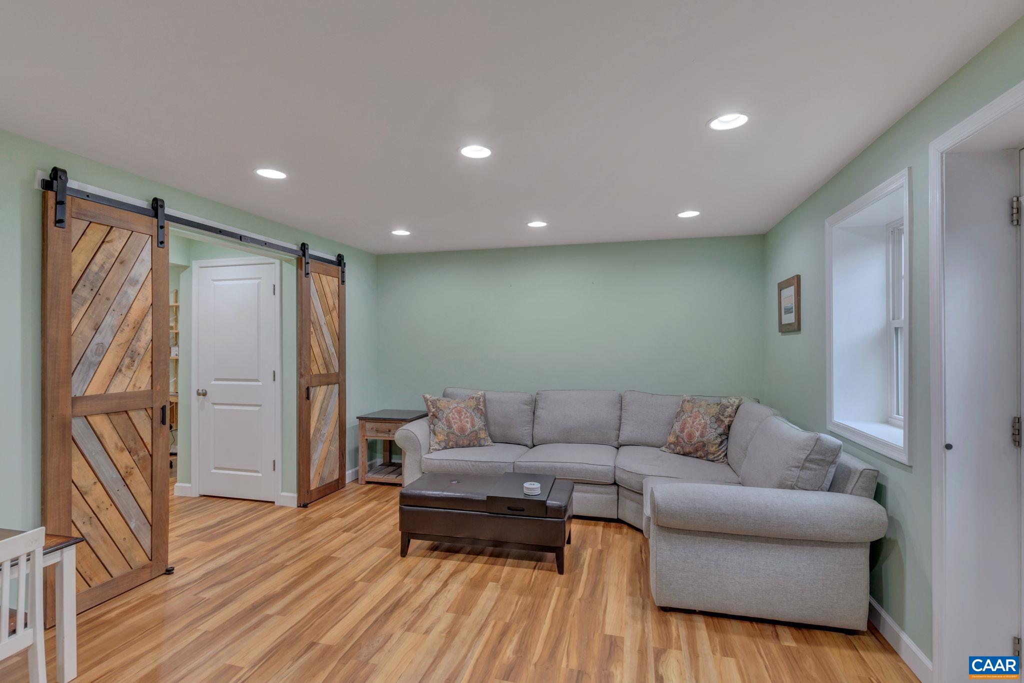 5543 Summerdean Road Crozet, VA 22932 - Photo 24 of 59 a living room with furniture and a wooden floor