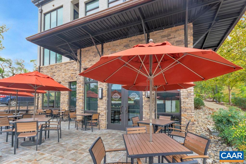 5543 Summerdean Road Crozet, VA 22932 - Photo 53 of 59 a view of patio with chairs and table under an umbrella with a barbeque