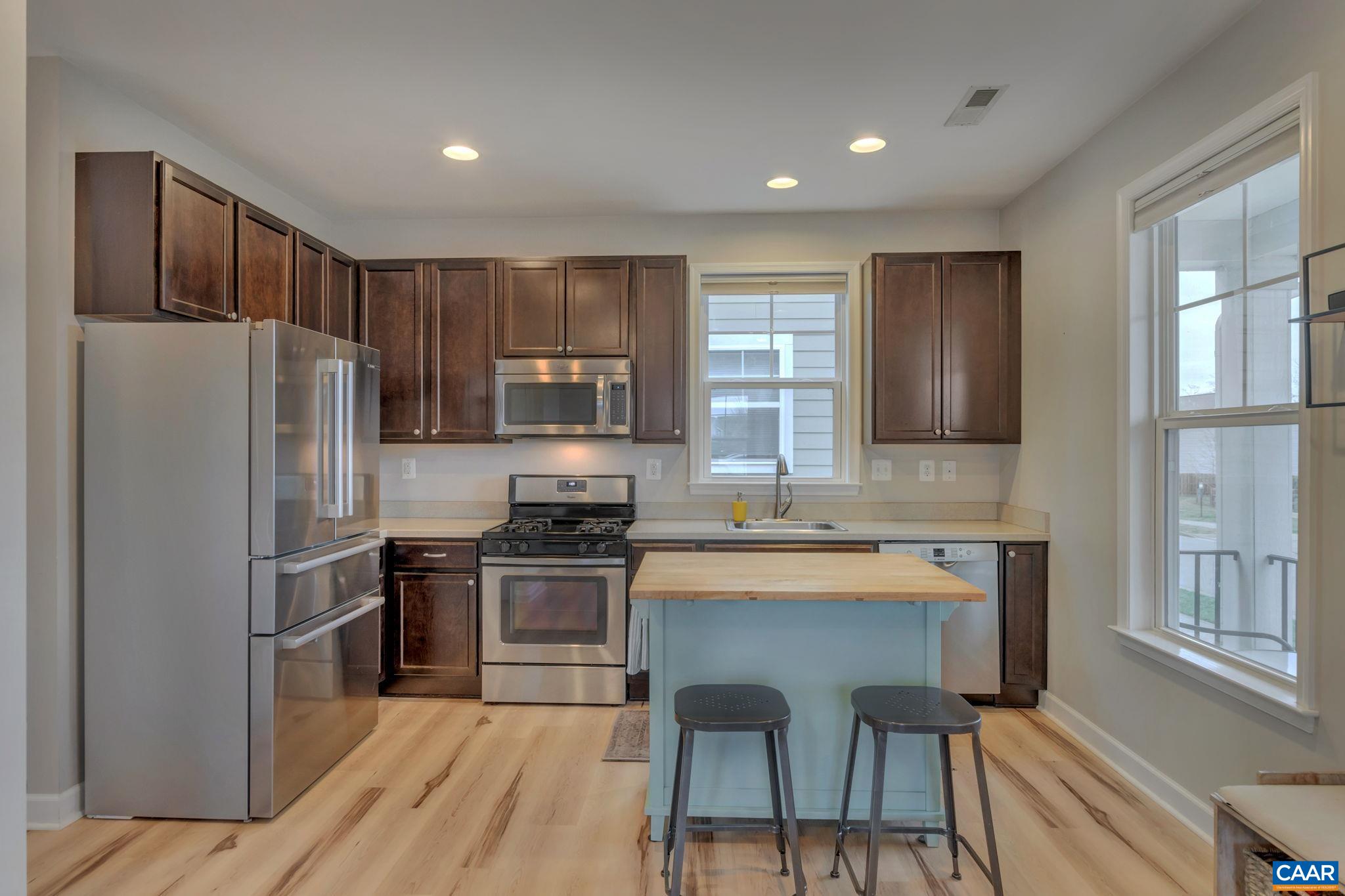 5543 Summerdean Road Crozet, VA 22932 - Photo 8 of 59 a kitchen with stainless steel appliances a stove a sink refrigerator and a refrigerator