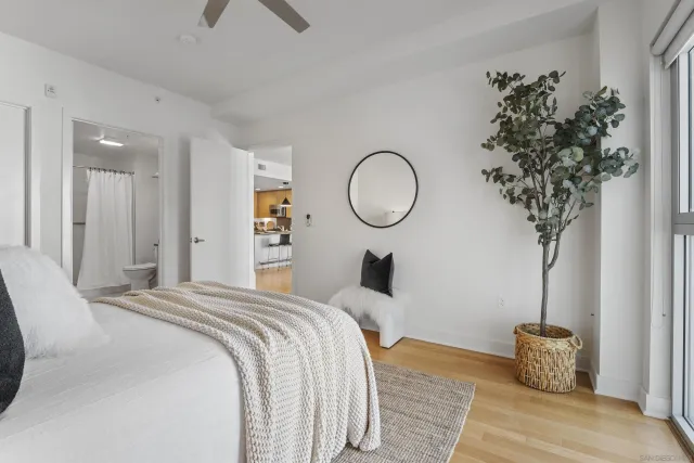 a bedroom with bed and a potted plant