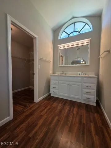 a room with a mirror and cabinets