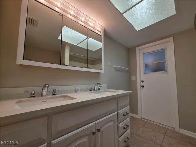 a bathroom with a tub a sink and a shower