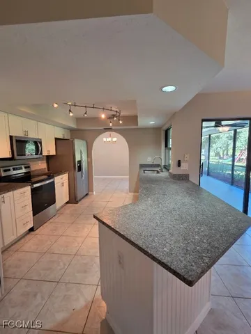 a kitchen with stainless steel appliances granite countertop a sink stove and granite counter top