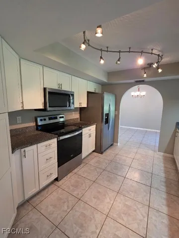 a large kitchen with cabinets and stainless steel appliances