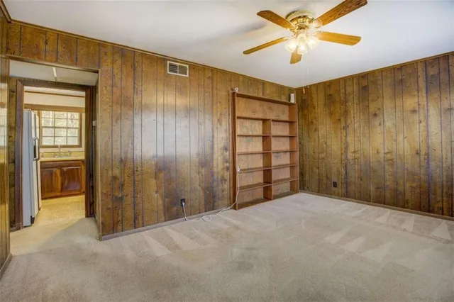 a view of empty room with a ceiling fan and a window