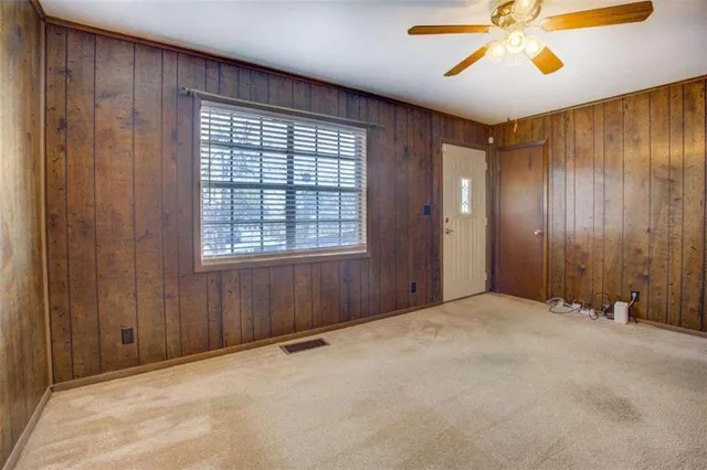 an empty room with windows and closet