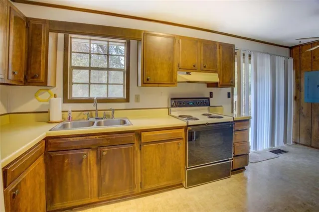 a kitchen with a sink stove and cabinets