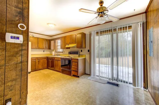 a kitchen that has a lot of cabinets and appliances