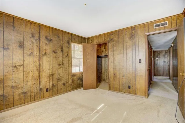 a view of a hallway with bathroom and shower