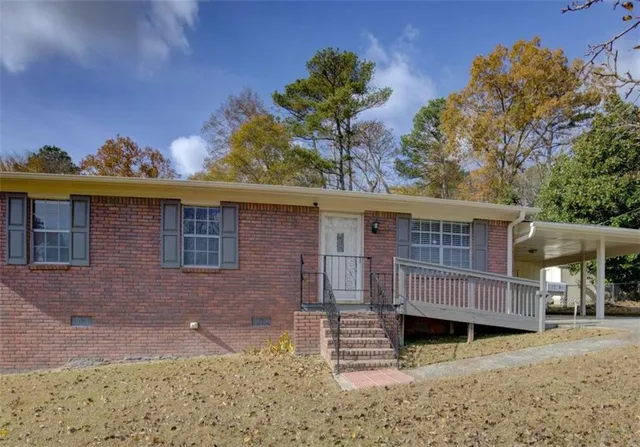 a view of a house with a window and wooden fence