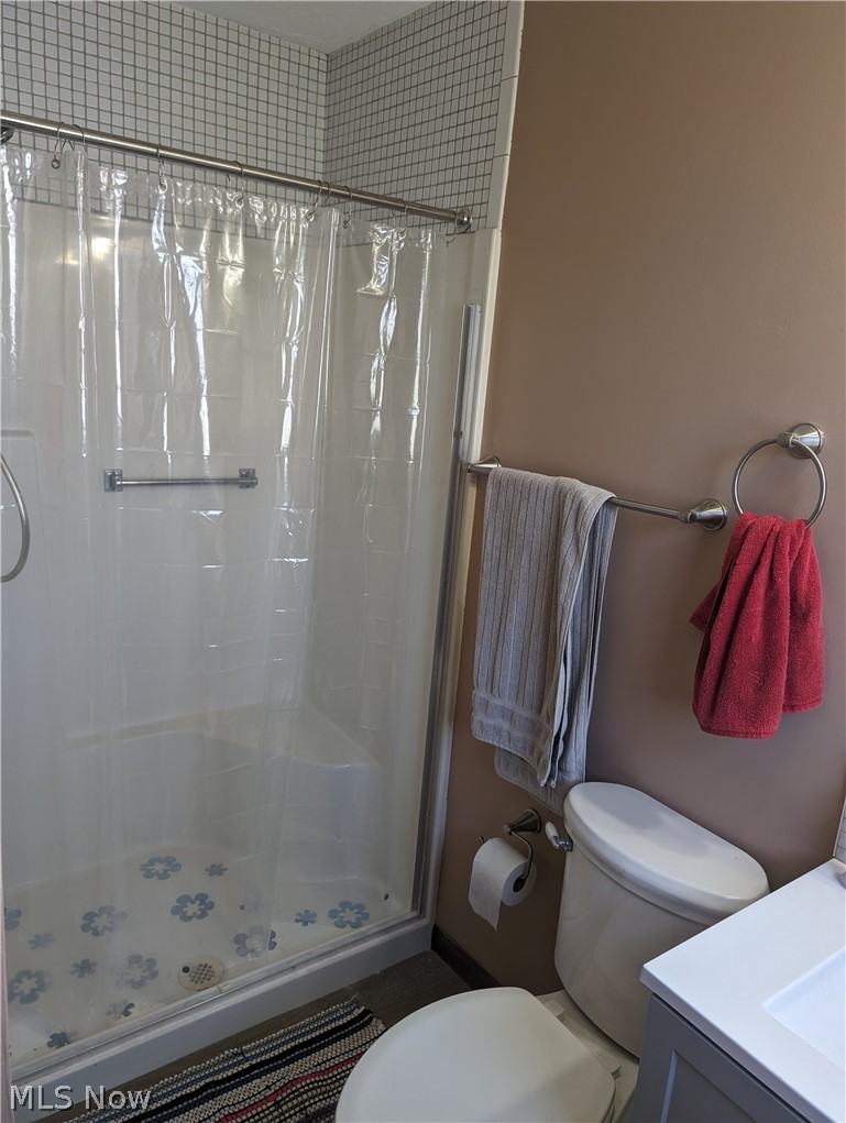 30213 Barjode Road Willowick, OH 44095 - Photo 13 of 20 Bathroom featuring walk in shower, toilet, and vanity