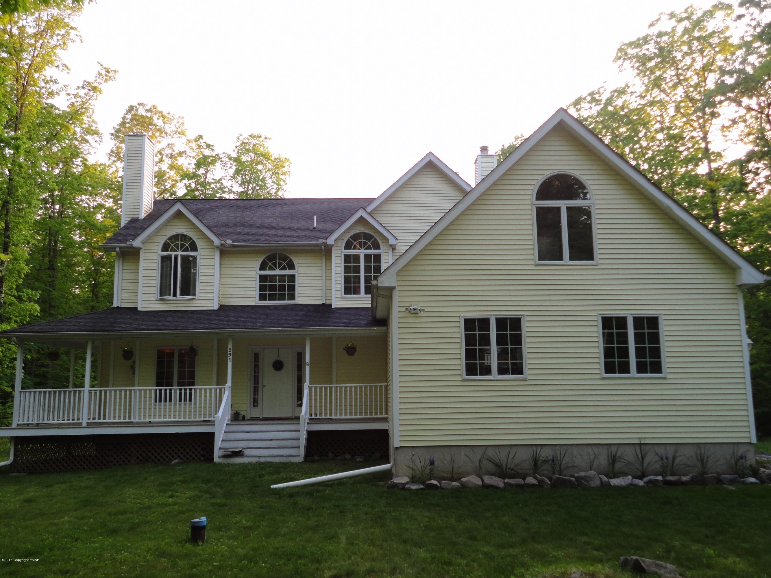 391 Turkey Ridge Road Mount Bethel, PA 18343 - Photo 1 of 19 a front view of a house with a garden