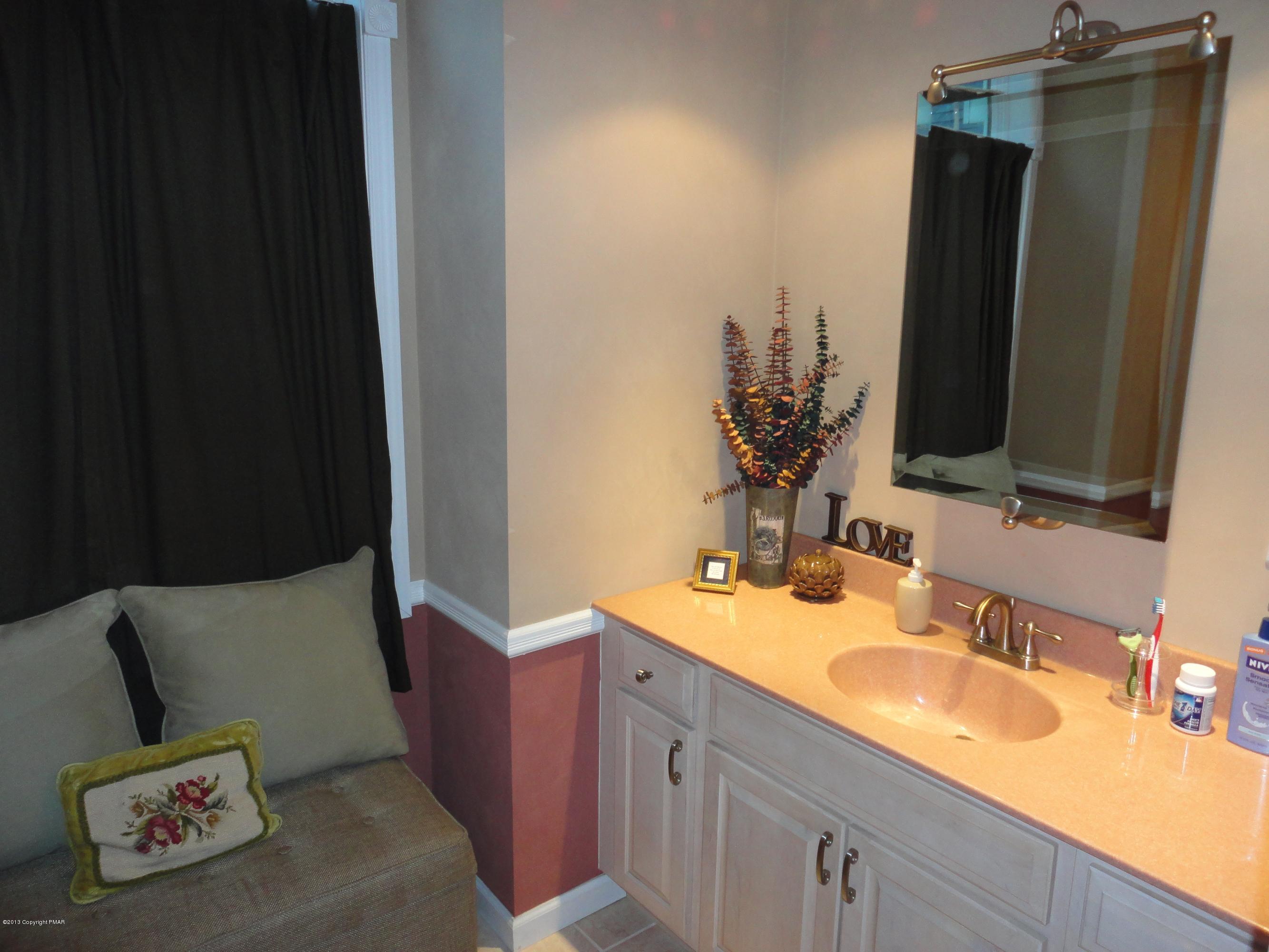 391 Turkey Ridge Road Mount Bethel, PA 18343 - Photo 14 of 19 a bathroom with a sink and a mirror