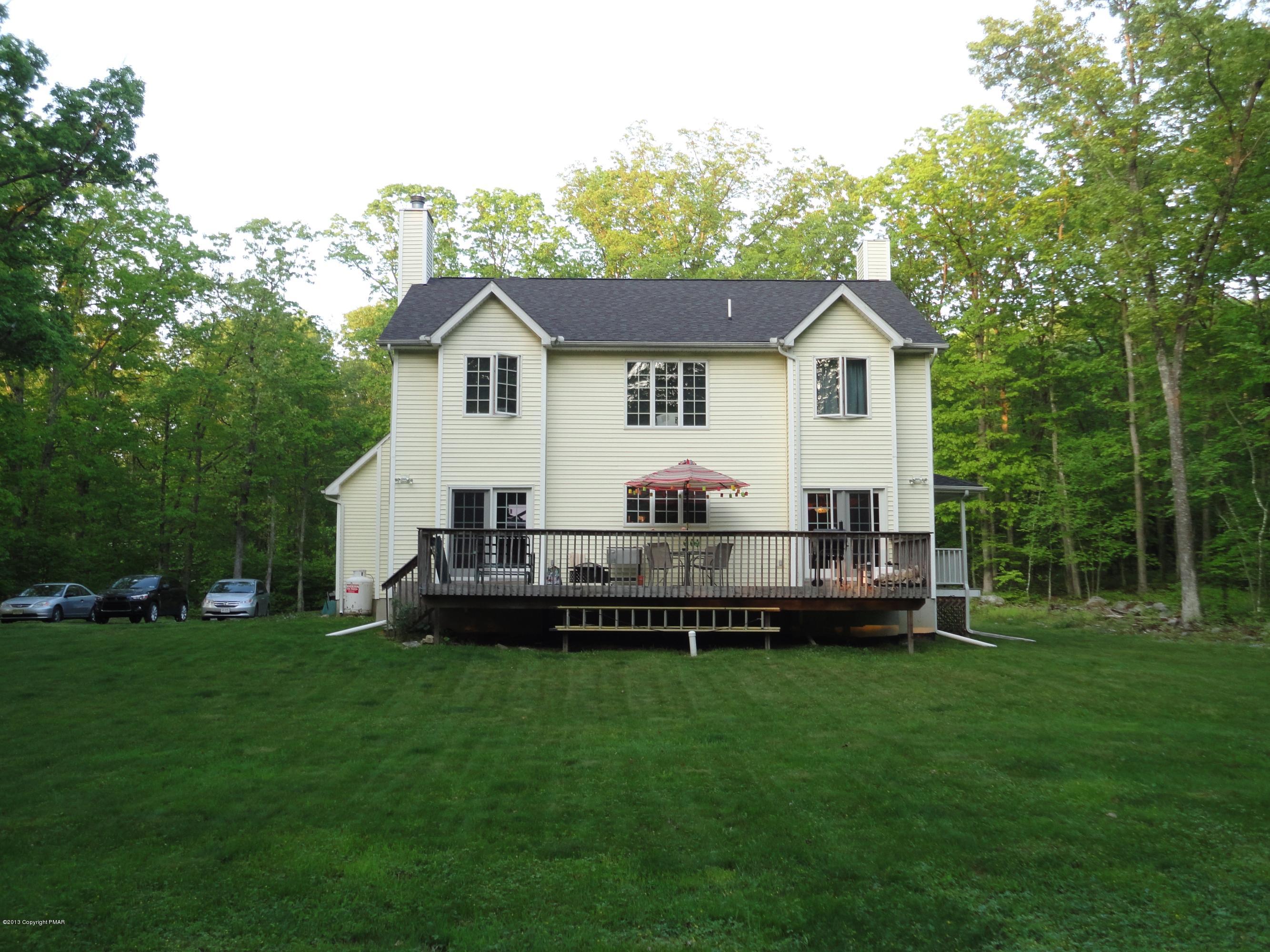 391 Turkey Ridge Road Mount Bethel, PA 18343 - Photo 18 of 19 a front view of a house with a garden and deck