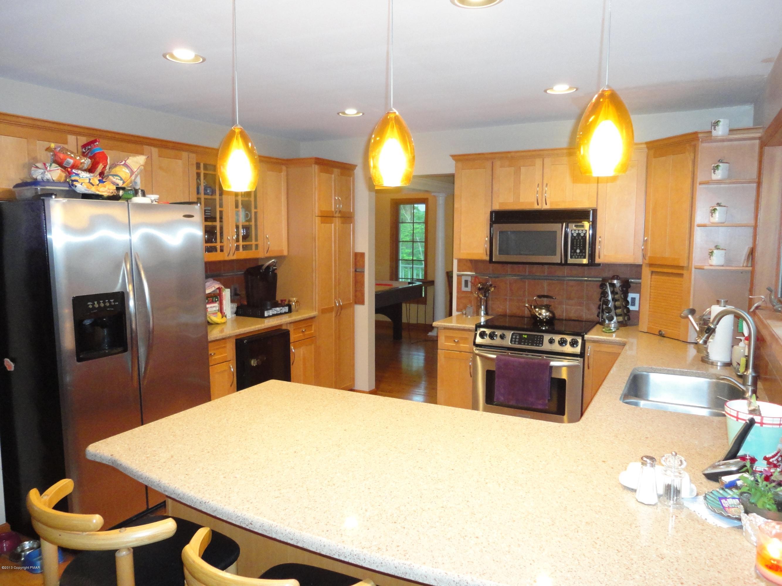 391 Turkey Ridge Road Mount Bethel, PA 18343 - Photo 5 of 19 a kitchen with stainless steel appliances a stove a refrigerator a sink a stove and island