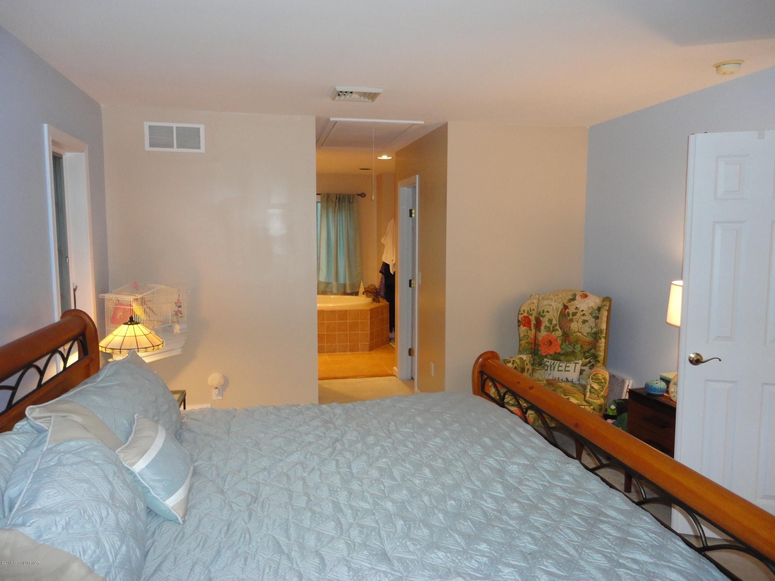 391 Turkey Ridge Road Mount Bethel, PA 18343 - Photo 10 of 19 a bedroom with bed and mirror