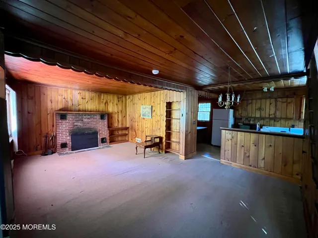 a view of an empty room with furniture and a fireplace